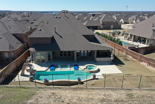 view of pool featuring a patio area, a fenced backyard, a residential view, and a water slide