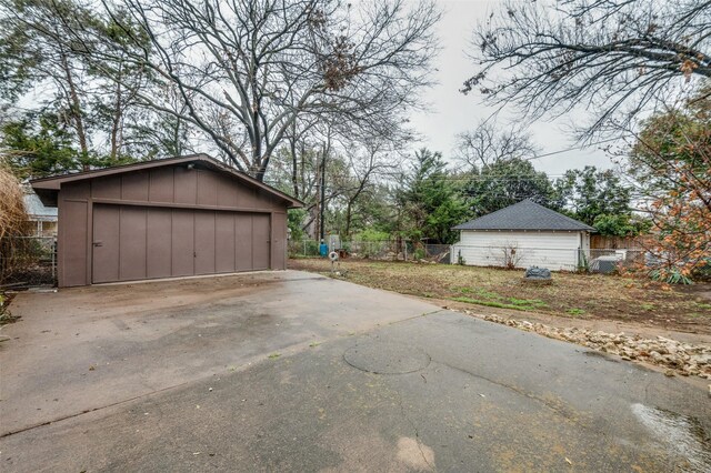 detached garage featuring fence