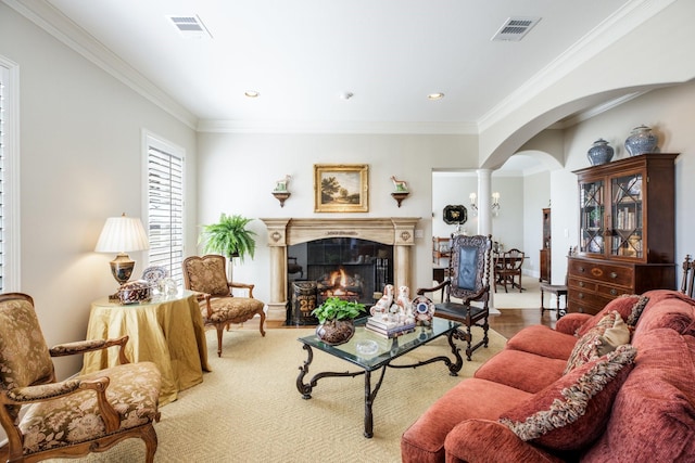 living area featuring arched walkways, visible vents, a lit fireplace, and ornamental molding