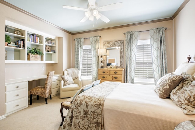 bedroom with ceiling fan, ornamental molding, carpet, and built in study area