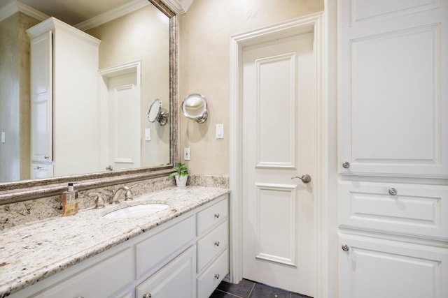 bathroom featuring tile patterned flooring, vanity, and ornamental molding