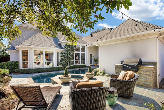 exterior space featuring an in ground hot tub, a patio area, and a grill