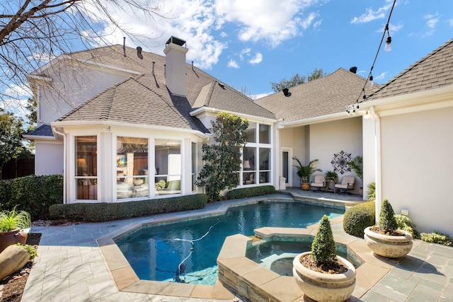 view of swimming pool featuring a patio area and a pool with connected hot tub