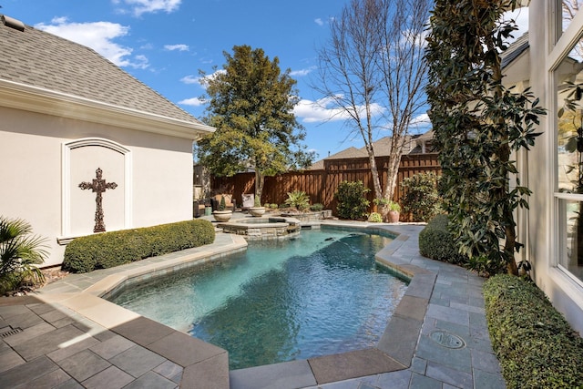 view of pool featuring a pool with connected hot tub, a fenced backyard, and a patio area