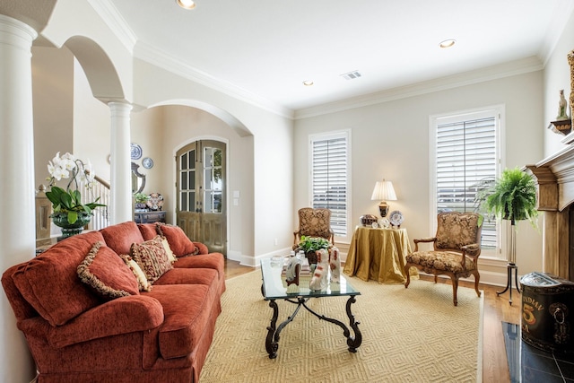 living area with visible vents, arched walkways, plenty of natural light, and ornate columns