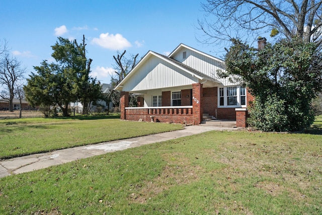 view of front of property with a front lawn and brick siding