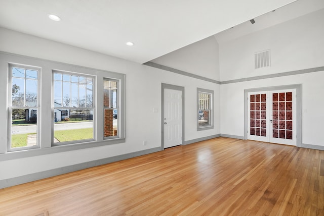 empty room featuring visible vents, french doors, baseboards, and wood finished floors