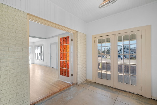 entryway with french doors and brick wall