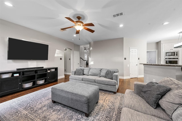 living room featuring visible vents, recessed lighting, wood finished floors, arched walkways, and a ceiling fan