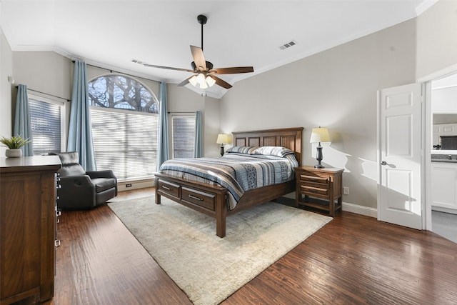 bedroom with visible vents, wood finished floors, and crown molding