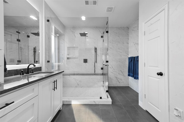 bathroom featuring vanity, visible vents, and a marble finish shower