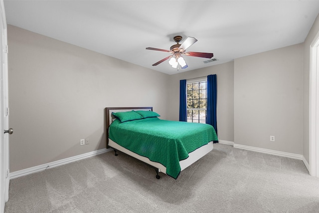 carpeted bedroom with visible vents, baseboards, and ceiling fan