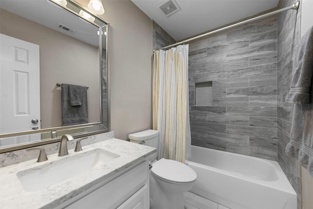 full bathroom with vanity, shower / tub combo, toilet, and visible vents