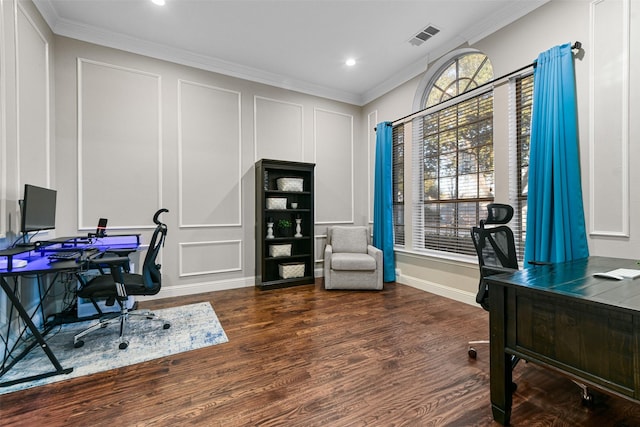 office space with wood finished floors, visible vents, baseboards, crown molding, and a decorative wall