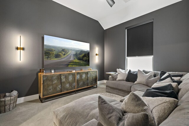 home theater with baseboards, vaulted ceiling, and carpet flooring