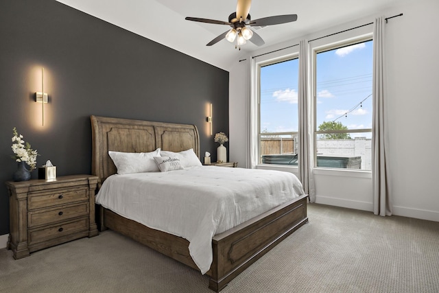 bedroom featuring a ceiling fan, baseboards, and light colored carpet