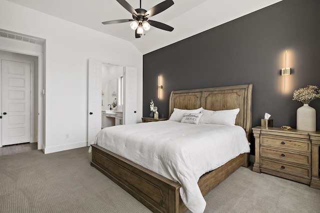 bedroom featuring connected bathroom, vaulted ceiling, carpet floors, baseboards, and visible vents