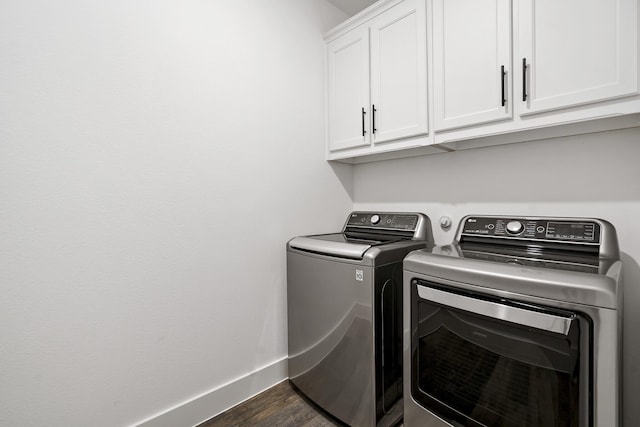 washroom with independent washer and dryer, cabinet space, dark wood-type flooring, and baseboards