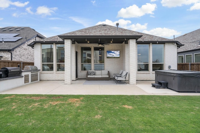 back of house with fence, a patio, brick siding, area for grilling, and a yard