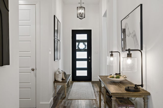 entrance foyer with baseboards and wood finished floors