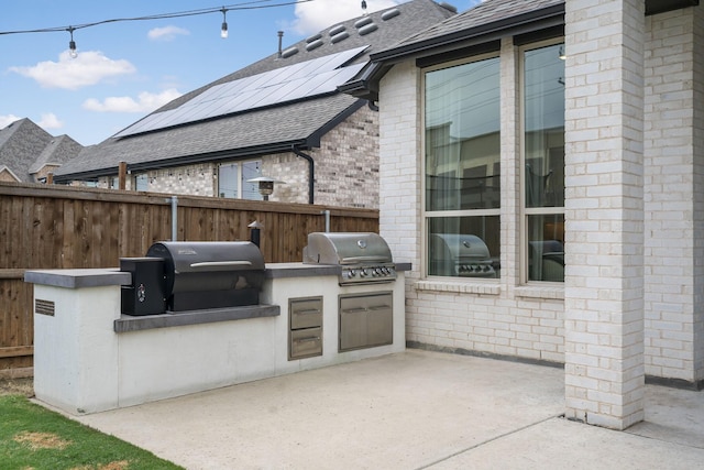 view of patio / terrace with an outdoor kitchen, area for grilling, and fence