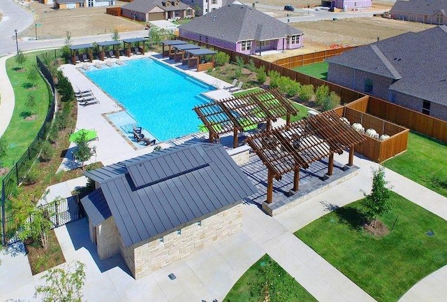 pool featuring a patio area, a residential view, and fence