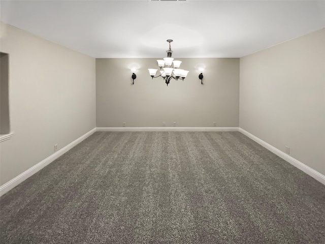 carpeted empty room with visible vents, baseboards, and a chandelier