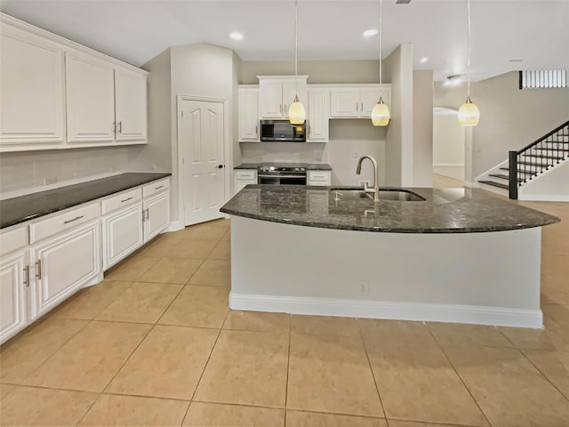 kitchen with a sink, light tile patterned flooring, white cabinetry, and stainless steel appliances