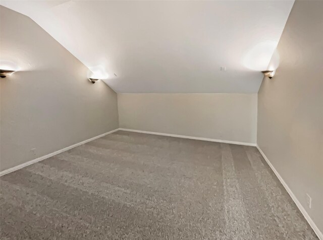 bonus room featuring vaulted ceiling, baseboards, and carpet floors