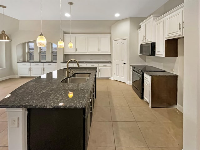 kitchen with light tile patterned floors, white cabinets, black appliances, and a sink