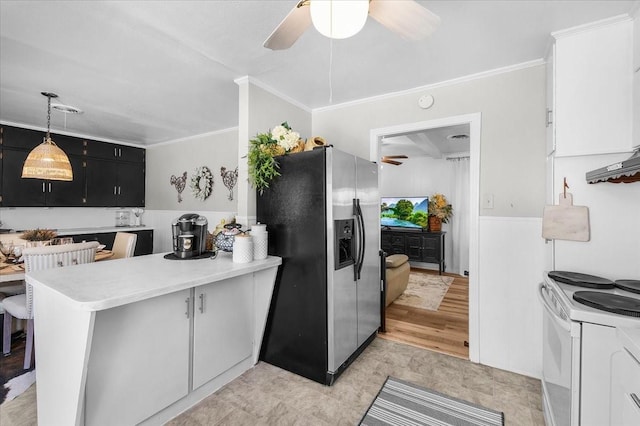 kitchen with ornamental molding, stainless steel fridge, a peninsula, light countertops, and dark cabinets