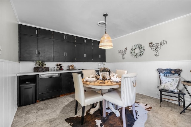 dining room with crown molding, visible vents, and wainscoting