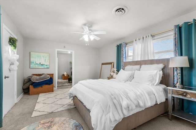 carpeted bedroom featuring visible vents and ceiling fan