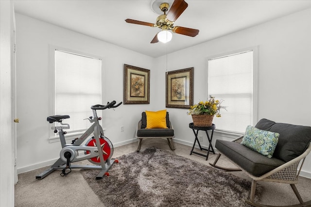 workout room with a ceiling fan, baseboards, a wealth of natural light, and carpet floors