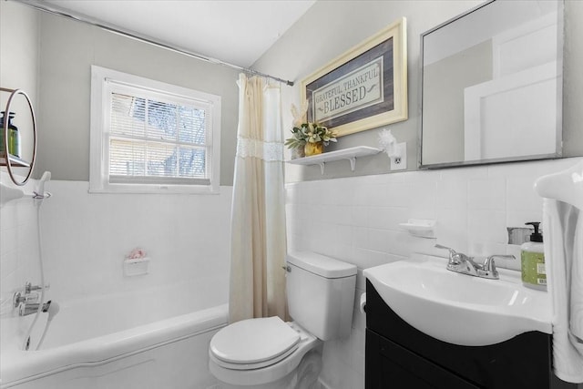 full bath with wainscoting, vanity, toilet, and tile walls