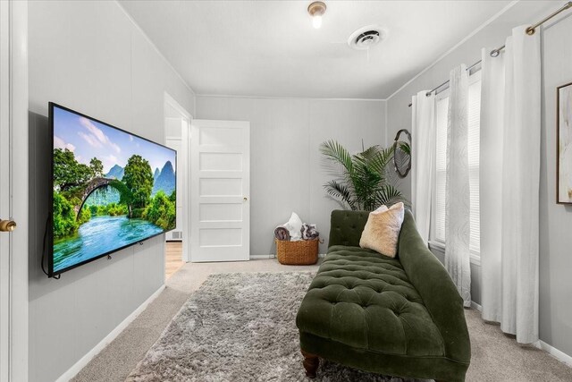 living area featuring light carpet, visible vents, and baseboards