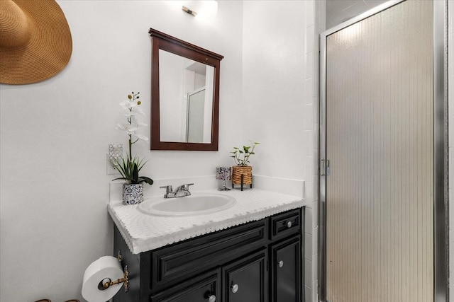 full bathroom with a stall shower and vanity