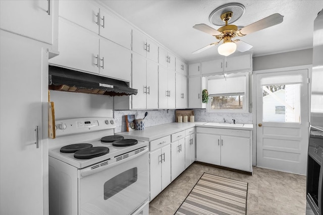 kitchen with electric stove, under cabinet range hood, a sink, white cabinets, and light countertops