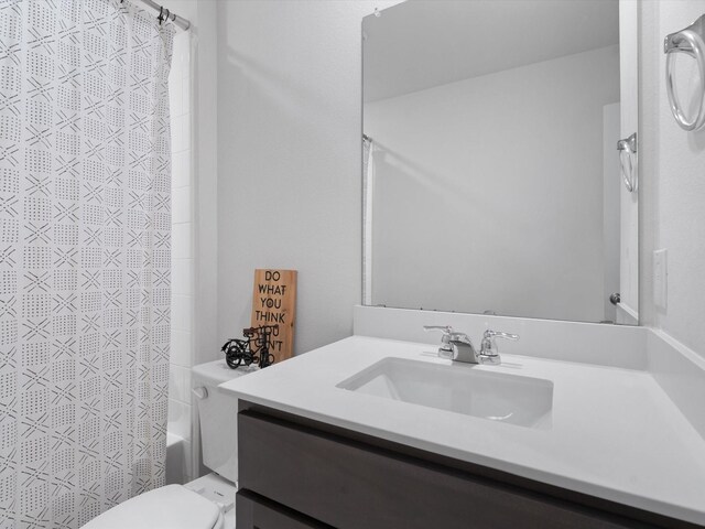 bathroom featuring vanity, toilet, and shower / tub combo with curtain