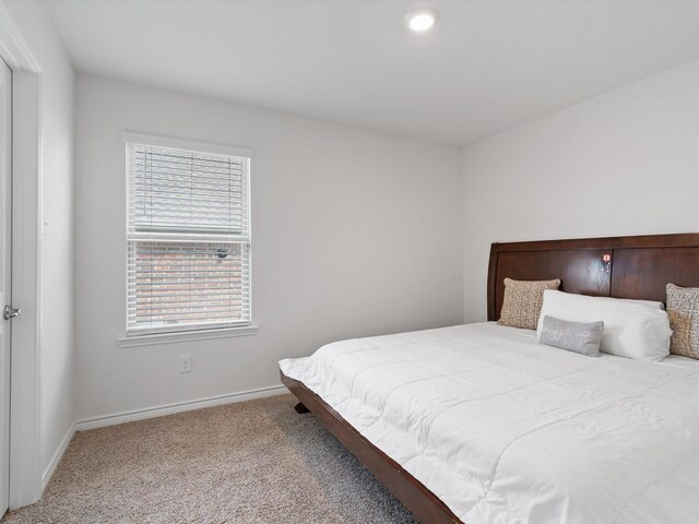 bedroom with baseboards and carpet flooring