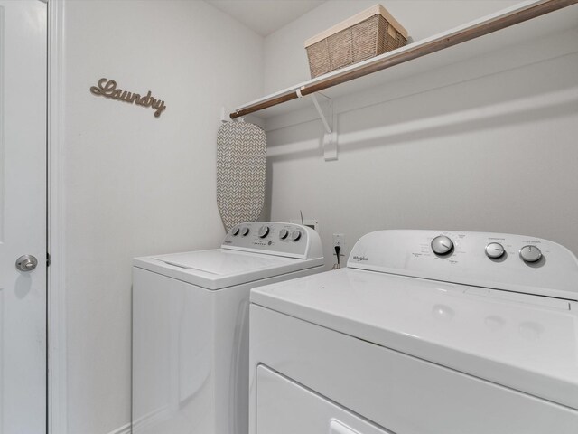 washroom featuring laundry area and washing machine and clothes dryer