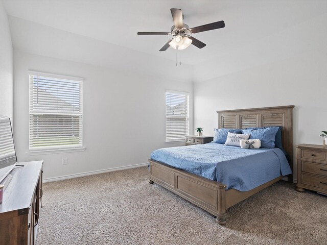 bedroom with light colored carpet, baseboards, and ceiling fan