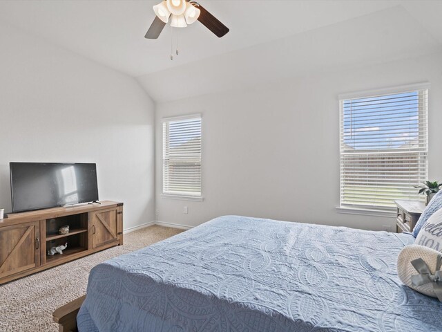 carpeted bedroom with baseboards, lofted ceiling, and a ceiling fan