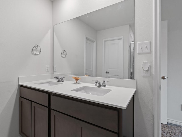 full bathroom with a sink and double vanity