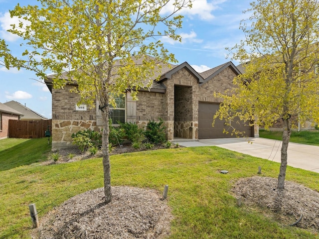 view of front facade featuring an attached garage, a front lawn, fence, stone siding, and driveway