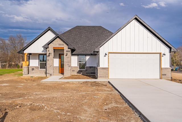 modern inspired farmhouse featuring board and batten siding, concrete driveway, roof with shingles, a garage, and stone siding