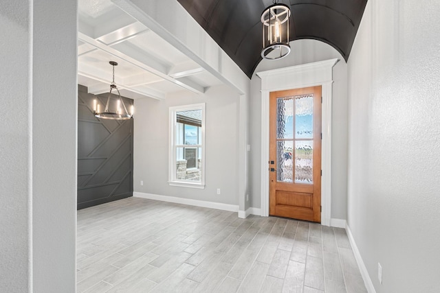 foyer entrance with baseboards, a chandelier, beam ceiling, wood finished floors, and coffered ceiling