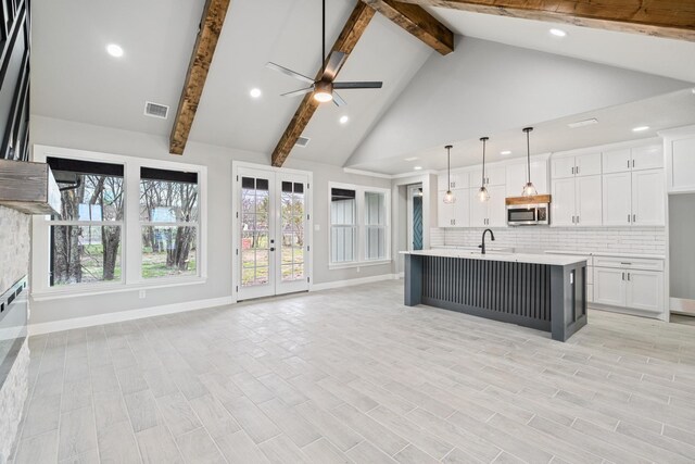 doorway featuring lofted ceiling, baseboards, and wood finished floors