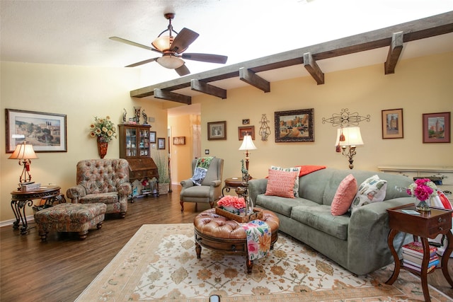 living room featuring a ceiling fan, beam ceiling, wood finished floors, and baseboards