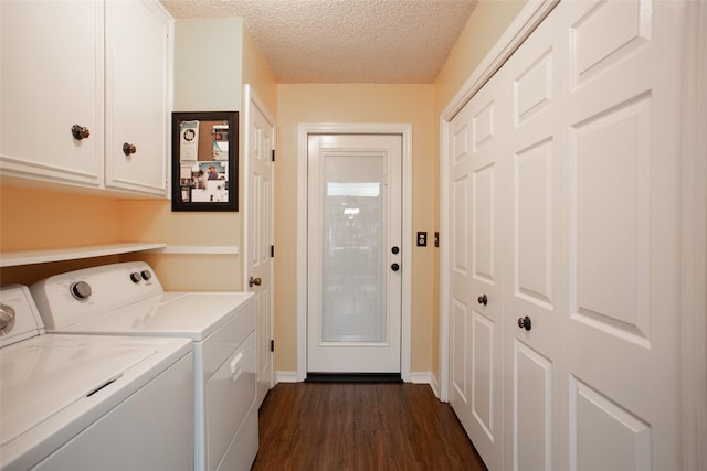 clothes washing area featuring baseboards, washer and clothes dryer, dark wood finished floors, cabinet space, and a textured ceiling